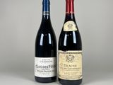 two bottles of wine sitting next to each other on a table
