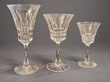 three clear glass goblets sitting on top of a table