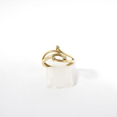 a close up of a gold ring with a diamond on it