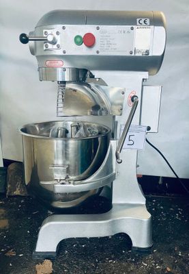 a mixer that is sitting on a stand in the kitchen