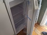 a white refrigerator with its door open in a kitchen