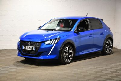 a blue car parked in a garage with a checkered floor