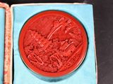 a red seal in a blue box on a table