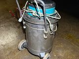 a metal bucket with a blue lid on a cart