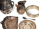 a silver tea pot, a silver plate, a silver spoon, and a silver teapot