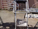 an image of a ladder and a chair in a yard