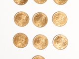 a lot of gold coins arranged in the shape of a heart