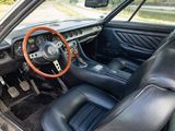 a car with a steering wheel and leather seats in it