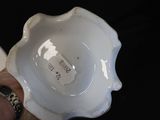 a person holding a white bowl with a tag on it