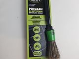 a close up of a green and black cleaning brush on a white surface