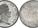 a close up of a coin on a white surface with a white background