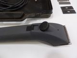 a black hair brush and a black comb on a white table