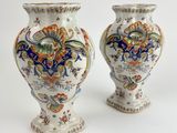 two vases sitting side by side on a white surface
