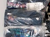 a lot of clothes that are wrapped in plastic bags