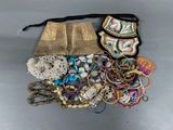 a bag full of assorted jewelry on a table