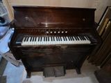 a piano that is sitting in the corner of a room