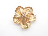 yellow glass flower brooch with a diamond center