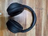 a pair of black headphones on a wooden table