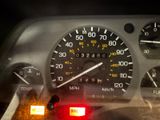 a close up of a car dashboard with various gauges and numbers