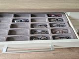 a drawer with glasses in it on the floor
