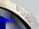 a close up of a watch with a blue glass on it