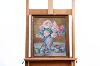 a painting on a easel with a vase of flowers on it