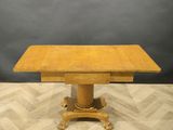 a wooden table with a square top on a wooden floor