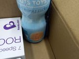a bottle of soda and a box of soda on the ground