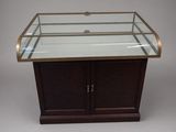 an image of a glass display case with a wooden base