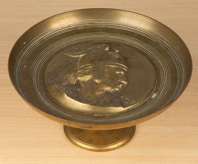 a gold plate with a picture of a man on it