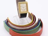 an image of a wrist watch sitting on top of a stack of belts