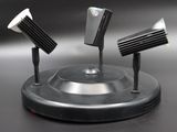 three lamps that are sitting on top of a stand