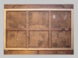 a wooden paneled wall with a window in it