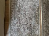 two rugs on the floor next to each other