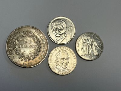 quatre pièces de monnaie britanniques différentes posées les unes à côté des autres sur une table