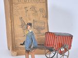 a toy of a man standing next to a box with a cart