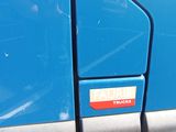 a blue truck with a sticker on the side of it