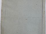 an old piece of paper sitting on top of a white table