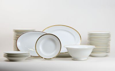 a lot of plates and bowls on the table