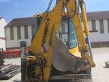 a backhoe of a construction vehicle that is parked in a lot