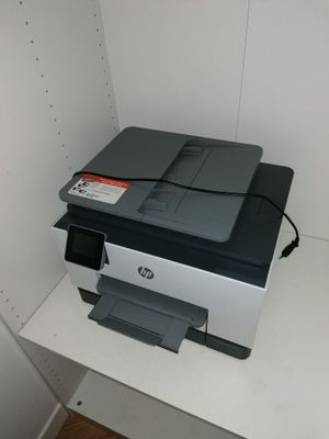 a printer that is sitting on a shelf in a room