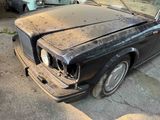 a black car that is sitting in a garage