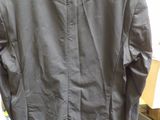 a jacket hanging on a hanger in a cluttered room