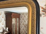 a large mirror hanging on a wall in a room