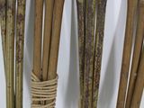 four wooden sticks tied together with rope on a white surface