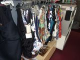 a closet with a lot of ties and bags on it