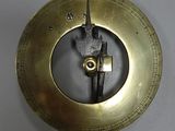 a clock hanging on a hook on the wall