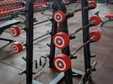 a gym with a lot of weights in the middle of the room