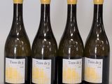 four bottles of wine are lined up on a table