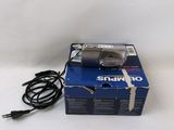 an open box of a digital camera sitting on top of a white surface